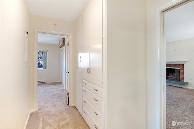 corridor featuring a baseboard radiator, light colored carpet, and a wall mounted air conditioner