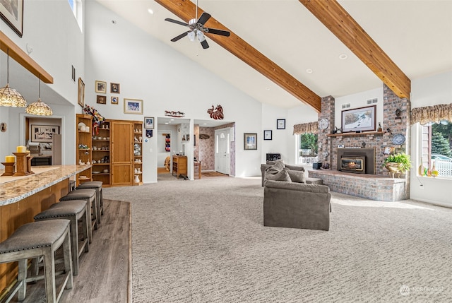 living room featuring dark carpet, ceiling fan, beamed ceiling, and high vaulted ceiling