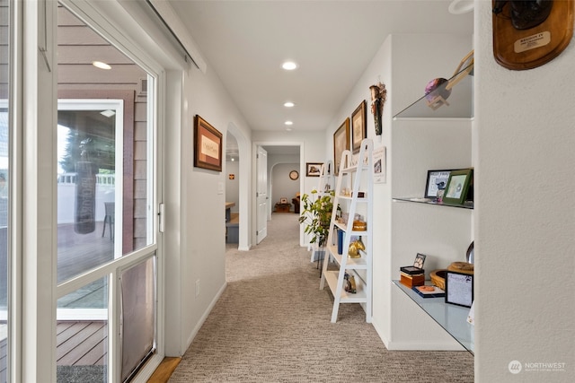 corridor featuring light colored carpet