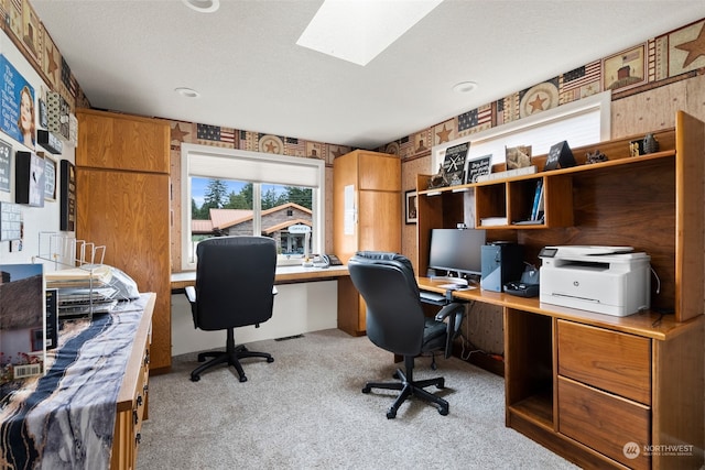 office with wooden walls, a textured ceiling, and light colored carpet