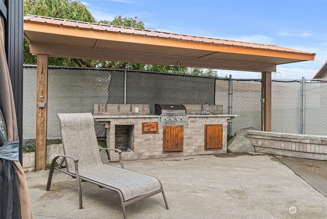 view of patio / terrace with exterior kitchen, a grill, and a gazebo