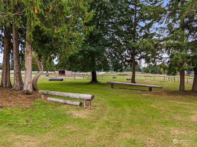 surrounding community featuring a yard and a rural view