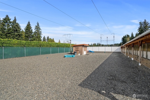 view of property's community with a shed