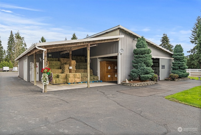 exterior space with an outbuilding and a garage