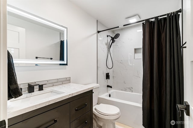 full bathroom featuring shower / tub combo with curtain, vanity, and toilet