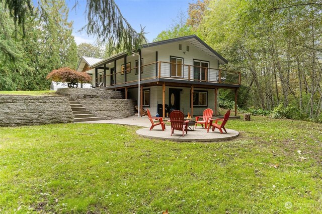 back of house featuring a balcony, a yard, and a patio