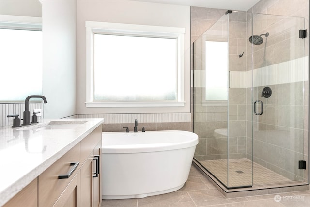 bathroom featuring vanity, separate shower and tub, and tile patterned floors