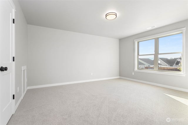 unfurnished room featuring light carpet