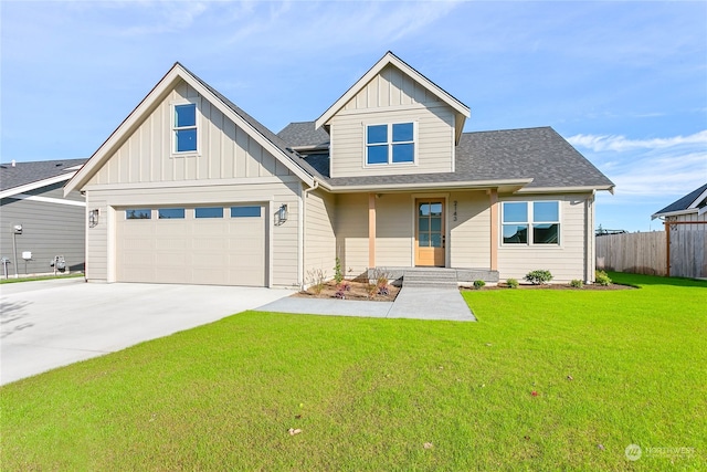 view of front of property featuring covered porch, a front yard, and a garage