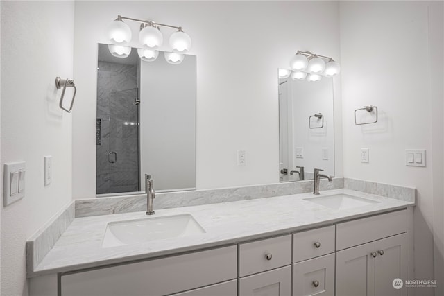 bathroom with vanity and a shower with door