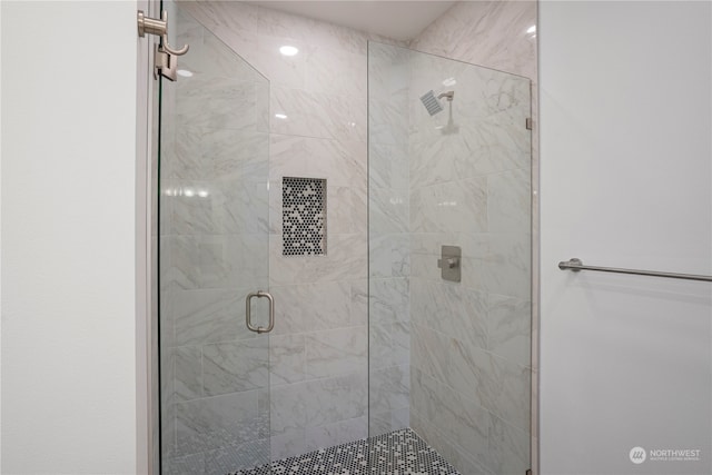 bathroom featuring a shower with shower door