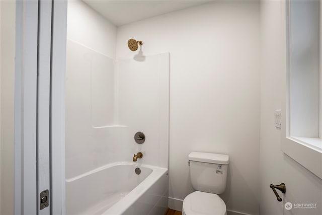 bathroom featuring shower / bath combination and toilet