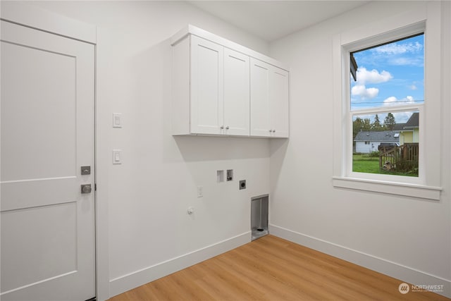 laundry room featuring hookup for an electric dryer, washer hookup, light wood-type flooring, cabinets, and hookup for a gas dryer