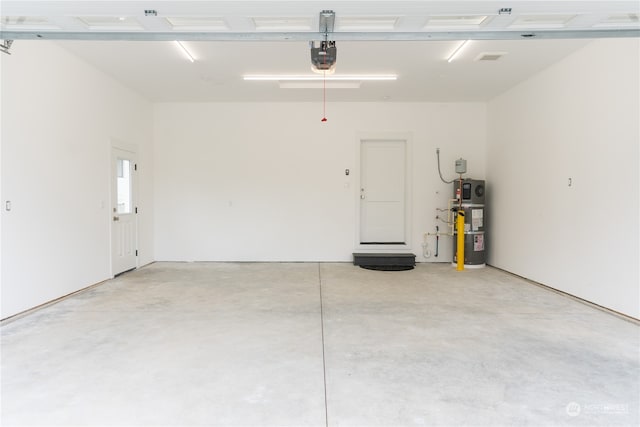 garage featuring a garage door opener and water heater