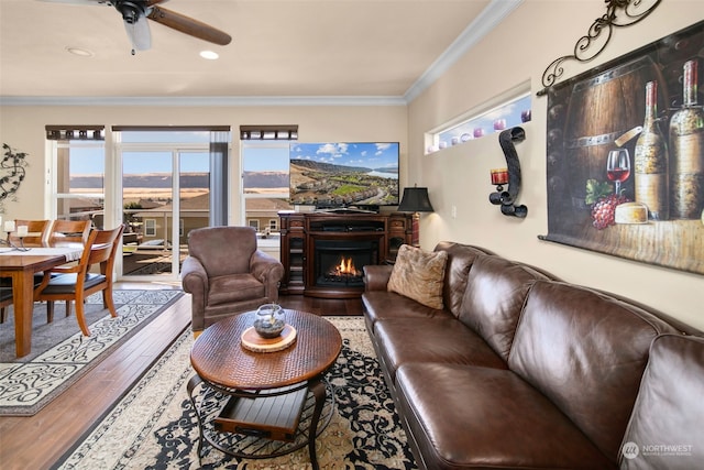 9225 Red Cliff Dr NW Unit B53, Quincy, WA 98848 - living area with wood-type flooring, crown molding, a warm lit fireplace, and ceiling fan
