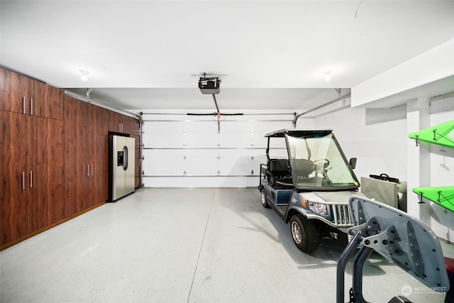 9225 Red Cliff Dr NW Unit B53, Quincy, WA 98848 - garage with wooden walls, stainless steel fridge, and a garage door opener