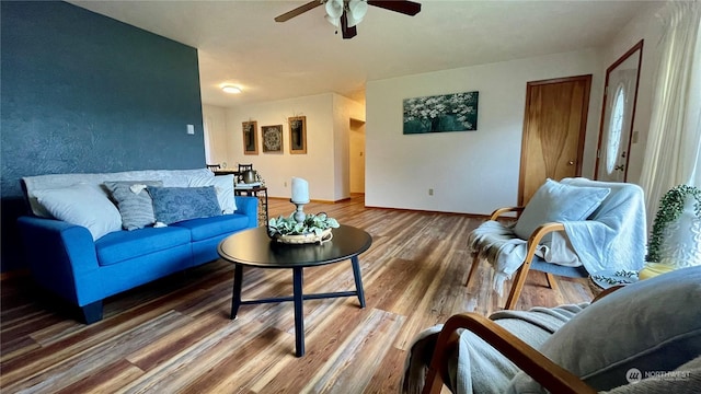 living room with hardwood / wood-style flooring and ceiling fan