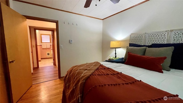 bedroom with ceiling fan, wood-type flooring, and crown molding