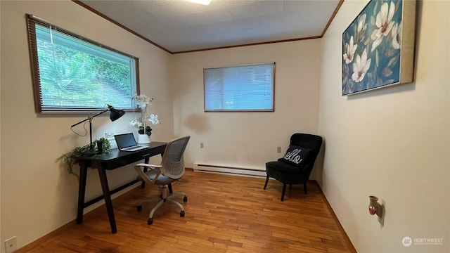 office area with crown molding, a baseboard radiator, and light wood-type flooring