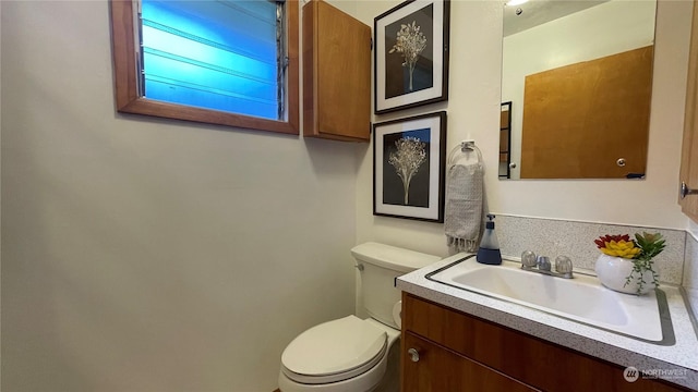 bathroom featuring vanity and toilet