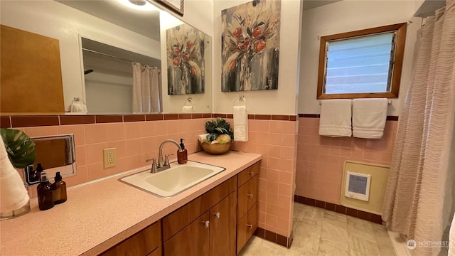 bathroom with vanity, tile patterned floors, and tile walls