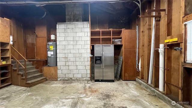 basement with stainless steel fridge with ice dispenser, plenty of natural light, and water heater