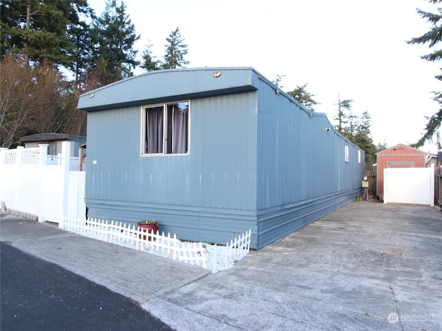 view of home's exterior featuring a storage shed