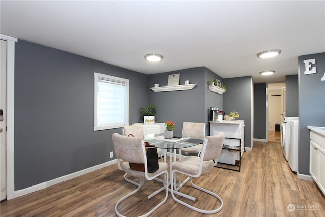 dining room featuring light hardwood / wood-style floors and washing machine and dryer