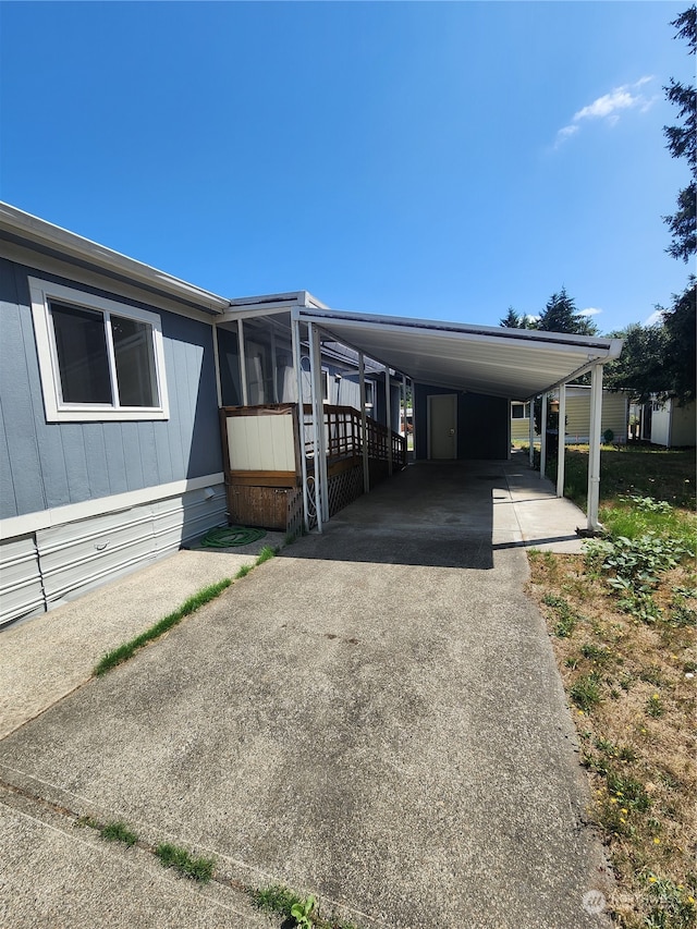 view of front facade with a sunroom and a carport