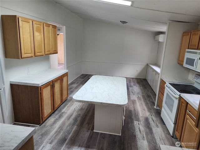 kitchen with white appliances, a kitchen island, and dark wood-type flooring