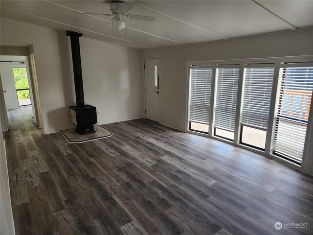 1111 Archwood Dr SW Unit 196, Olympia, WA 98502 - unfurnished living room with a ceiling fan, a wood stove, and wood finished floors