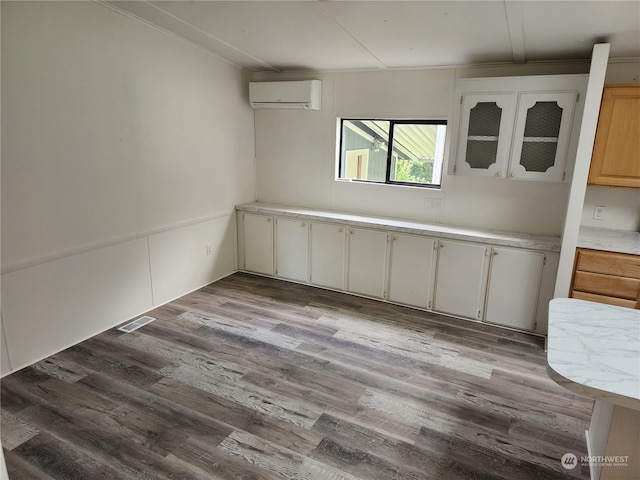 interior space featuring light hardwood / wood-style floors and a wall mounted air conditioner