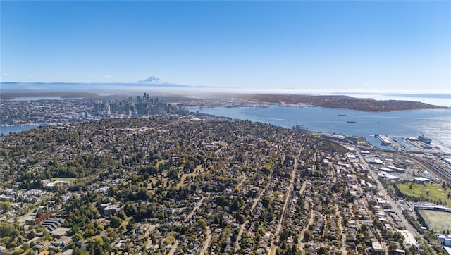 birds eye view of property with a water and mountain view