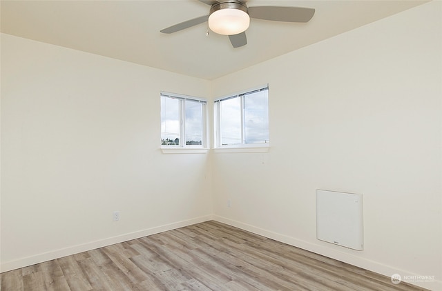 spare room with light wood-type flooring and ceiling fan