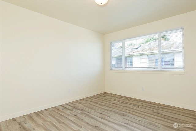 spare room with light wood-type flooring