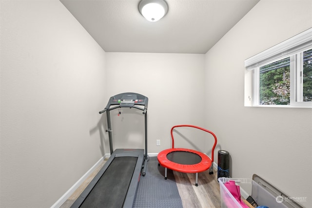 workout area with wood-type flooring