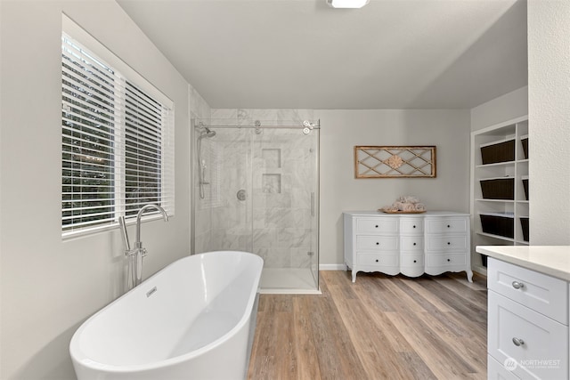 bathroom with vanity, hardwood / wood-style floors, and separate shower and tub