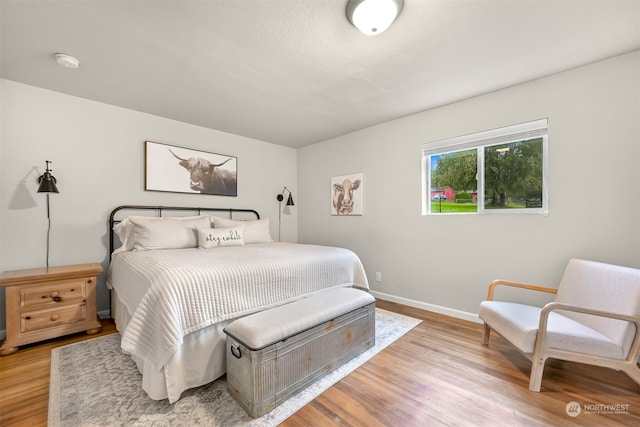 bedroom with hardwood / wood-style flooring