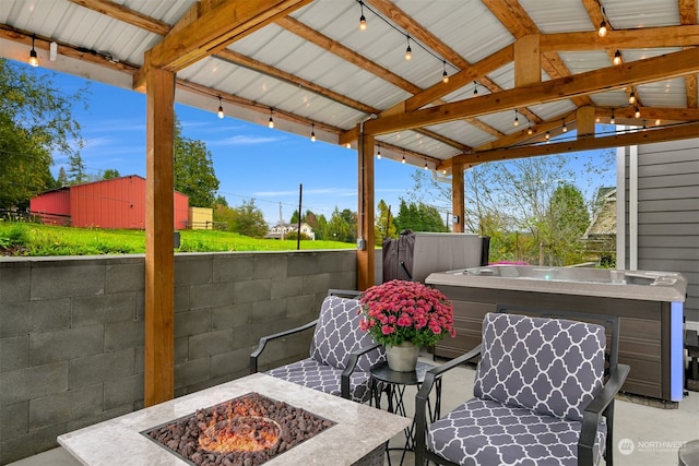 view of patio with a hot tub, a gazebo, and a fire pit