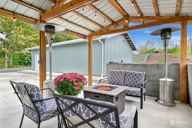 view of patio / terrace with a gazebo and an outdoor living space with a fire pit