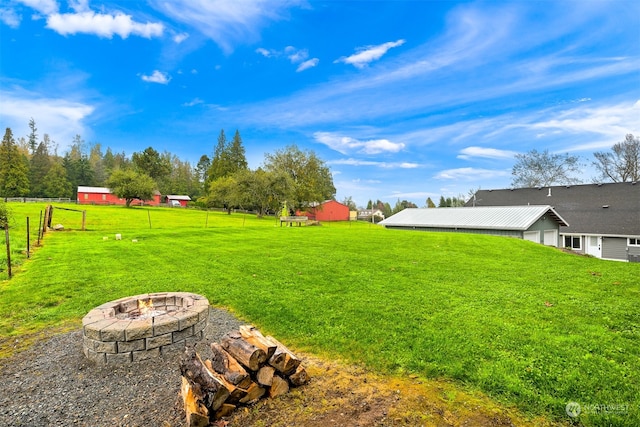 view of yard featuring an outdoor fire pit and an outbuilding