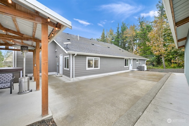 rear view of property featuring central AC and a patio