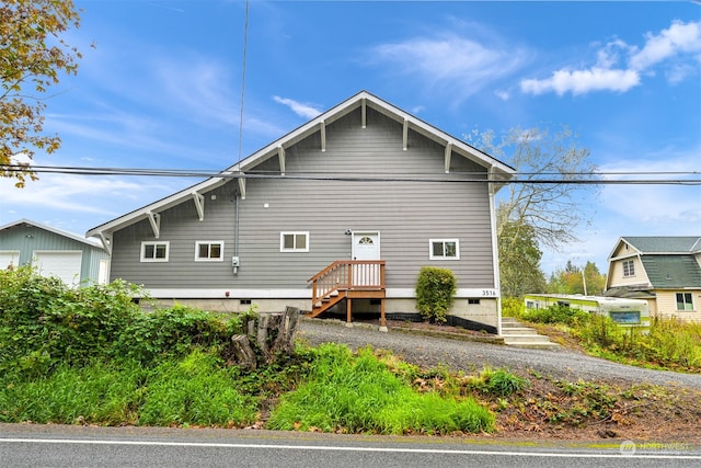 rear view of house with a garage