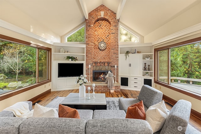 living room with a brick fireplace, light wood-type flooring, beam ceiling, and high vaulted ceiling