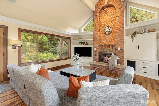 living room featuring high vaulted ceiling, beam ceiling, light hardwood / wood-style flooring, and a brick fireplace