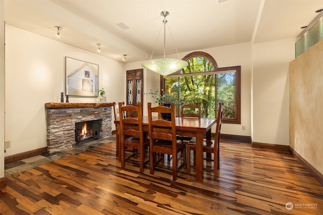 dining area with a fireplace and dark hardwood / wood-style flooring