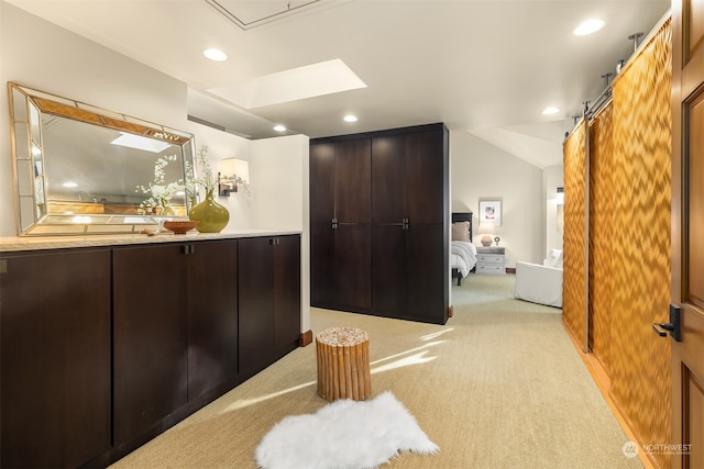 bathroom with lofted ceiling with skylight and vanity