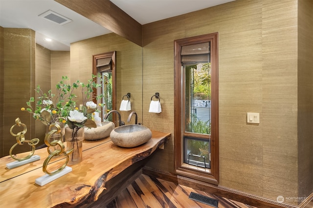 interior space featuring beamed ceiling and hardwood / wood-style flooring