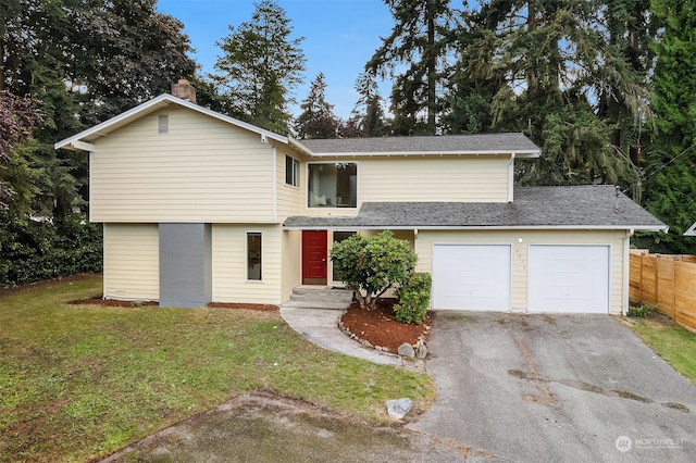 front facade with a garage and a front yard