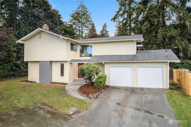 view of front property featuring a garage and a front yard